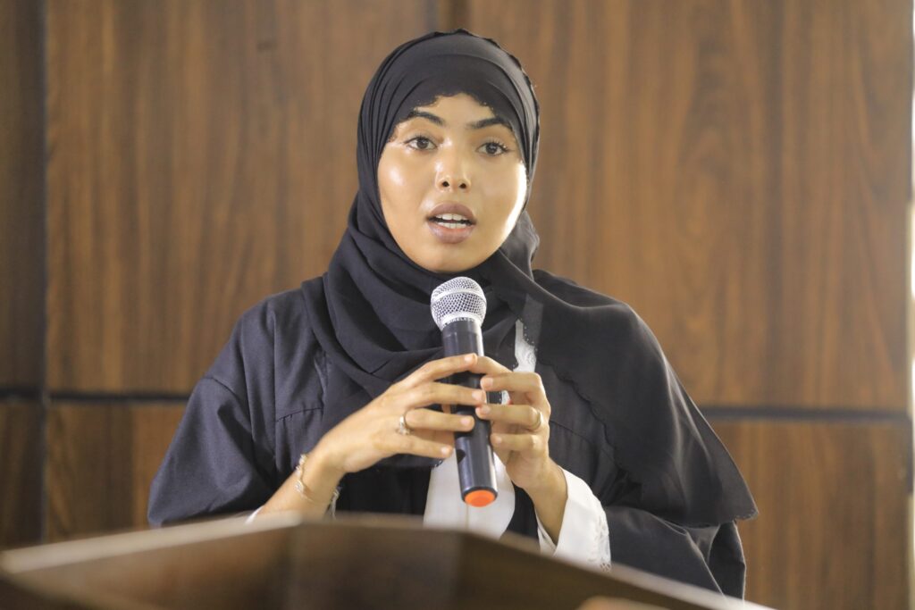 A researcher presenting her work at a SIMAD conference